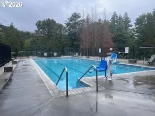 a living room with table chairs and a dining table with wooden floor