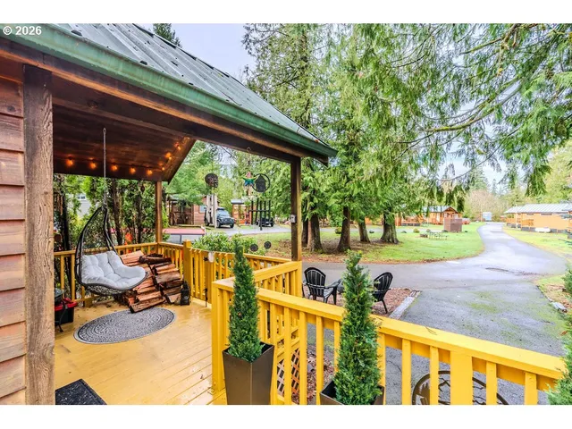 a view of swimming pool with outdoor seating and trees in the background