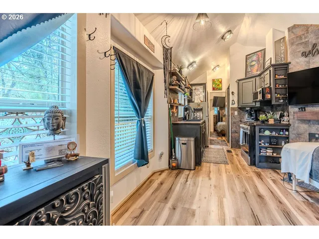 a open kitchen with kitchen island a stove and a wooden floor