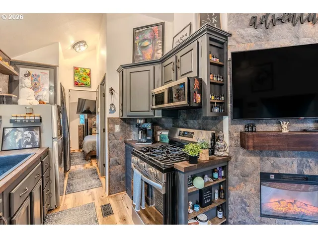a kitchen with stainless steel appliances granite countertop a stove and a microwave