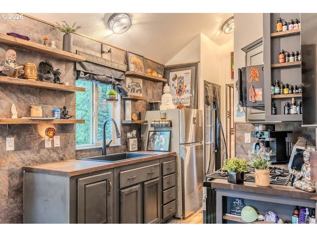 a kitchen with stainless steel appliances granite countertop a sink and cabinets