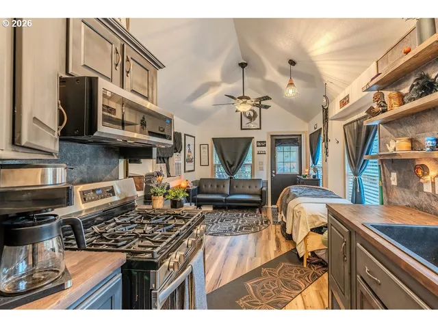 a kitchen with stainless steel appliances granite countertop a stove and a sink