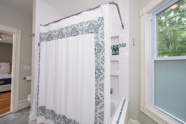 a bathroom with a shower and a mirror