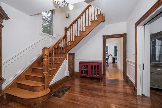 a view of entryway and hall with wooden floor