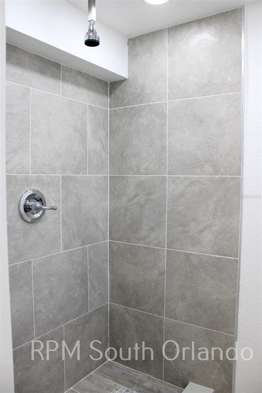 1245 North Pine Hills Road Orlando, FL 32808 - Photo 9 of 14 a bathroom with a shower