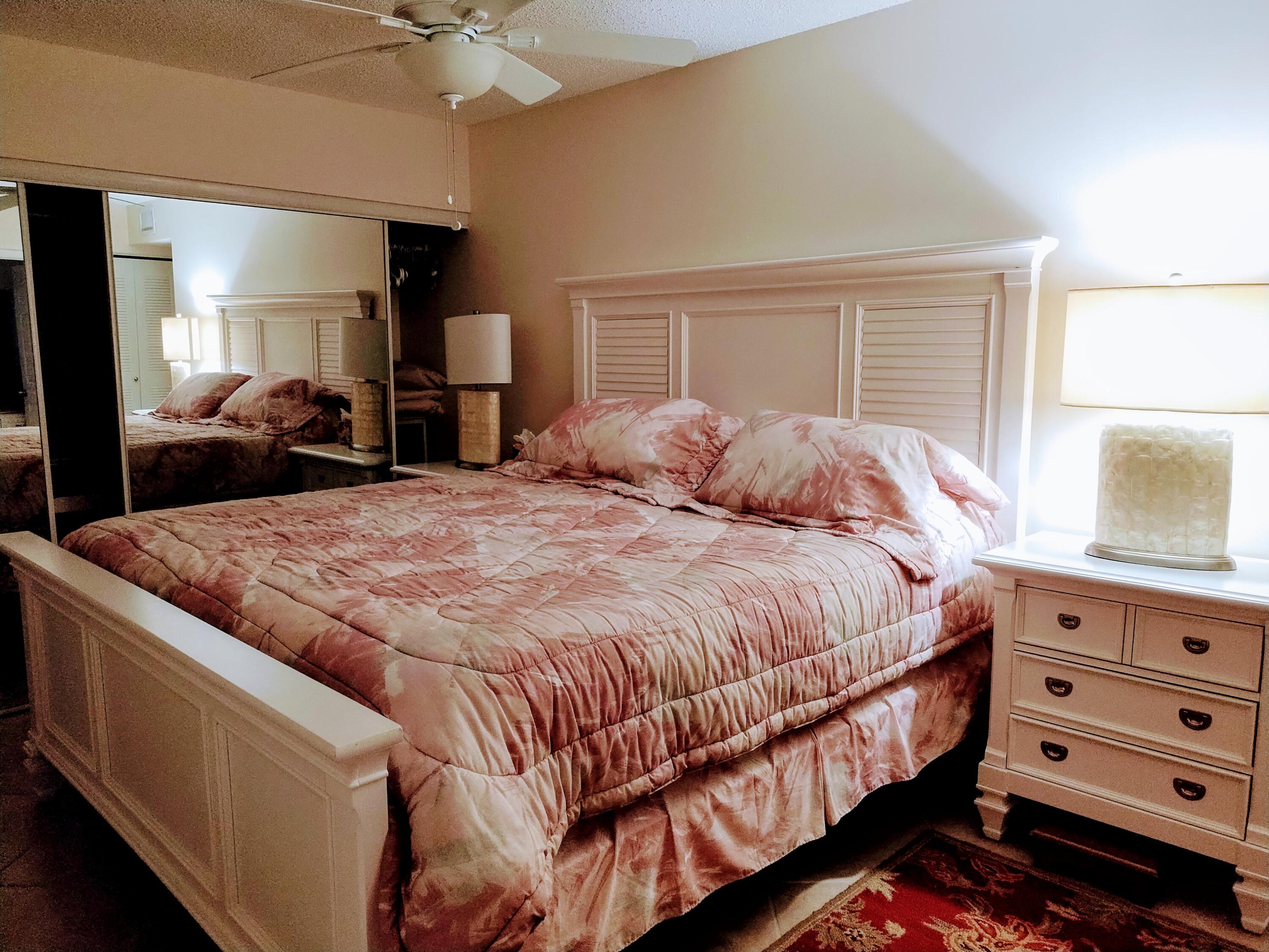 14716 Canalview Drive, Unit D Delray Beach, FL 33484 - Photo 11 of 17 a bedroom with a bed and dresser