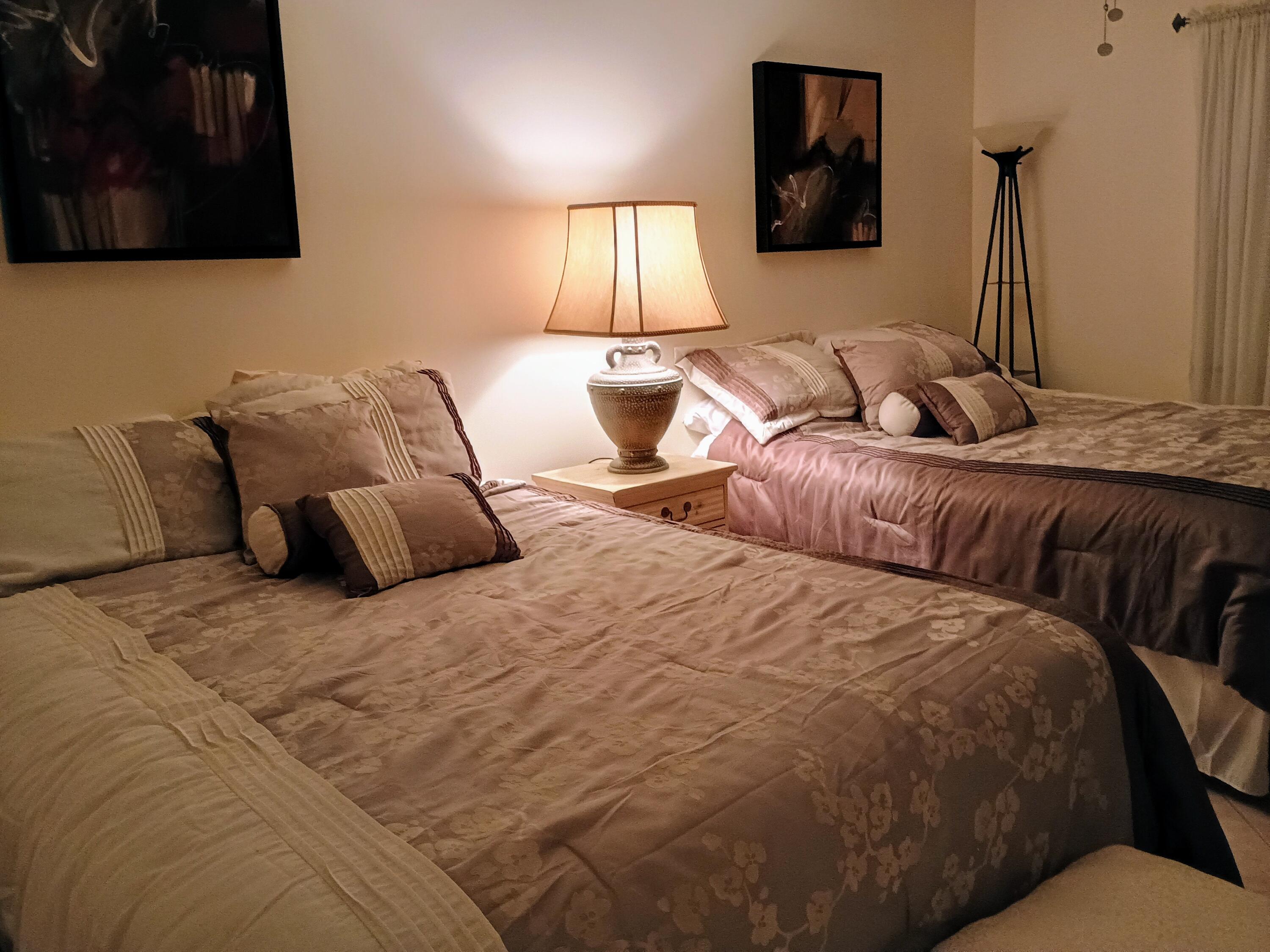 14716 Canalview Drive, Unit D Delray Beach, FL 33484 - Photo 14 of 17 a large bed sitting in a bedroom and lamp