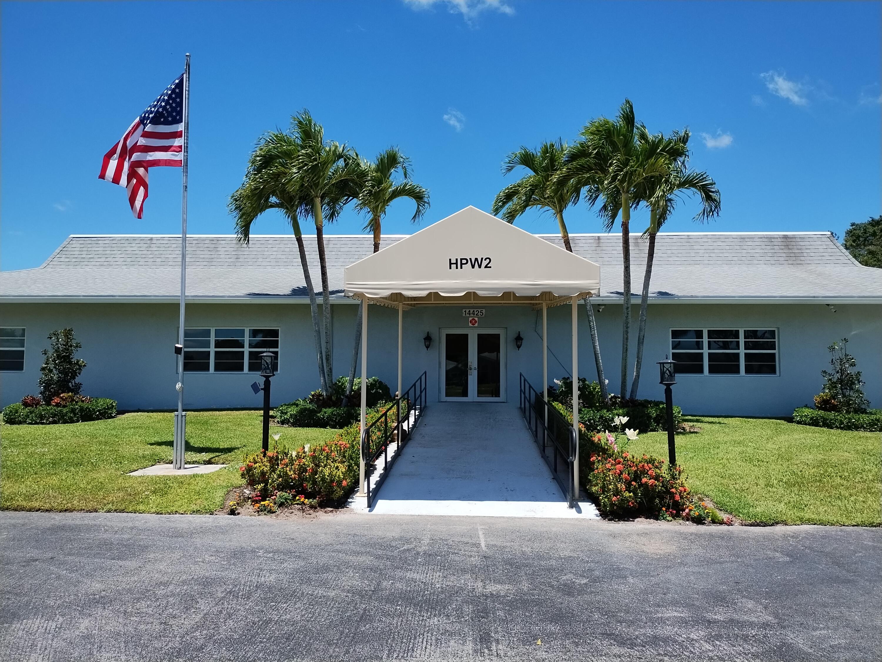 14716 Canalview Drive, Unit D Delray Beach, FL 33484 - Photo 15 of 17 a front view of a house with garden