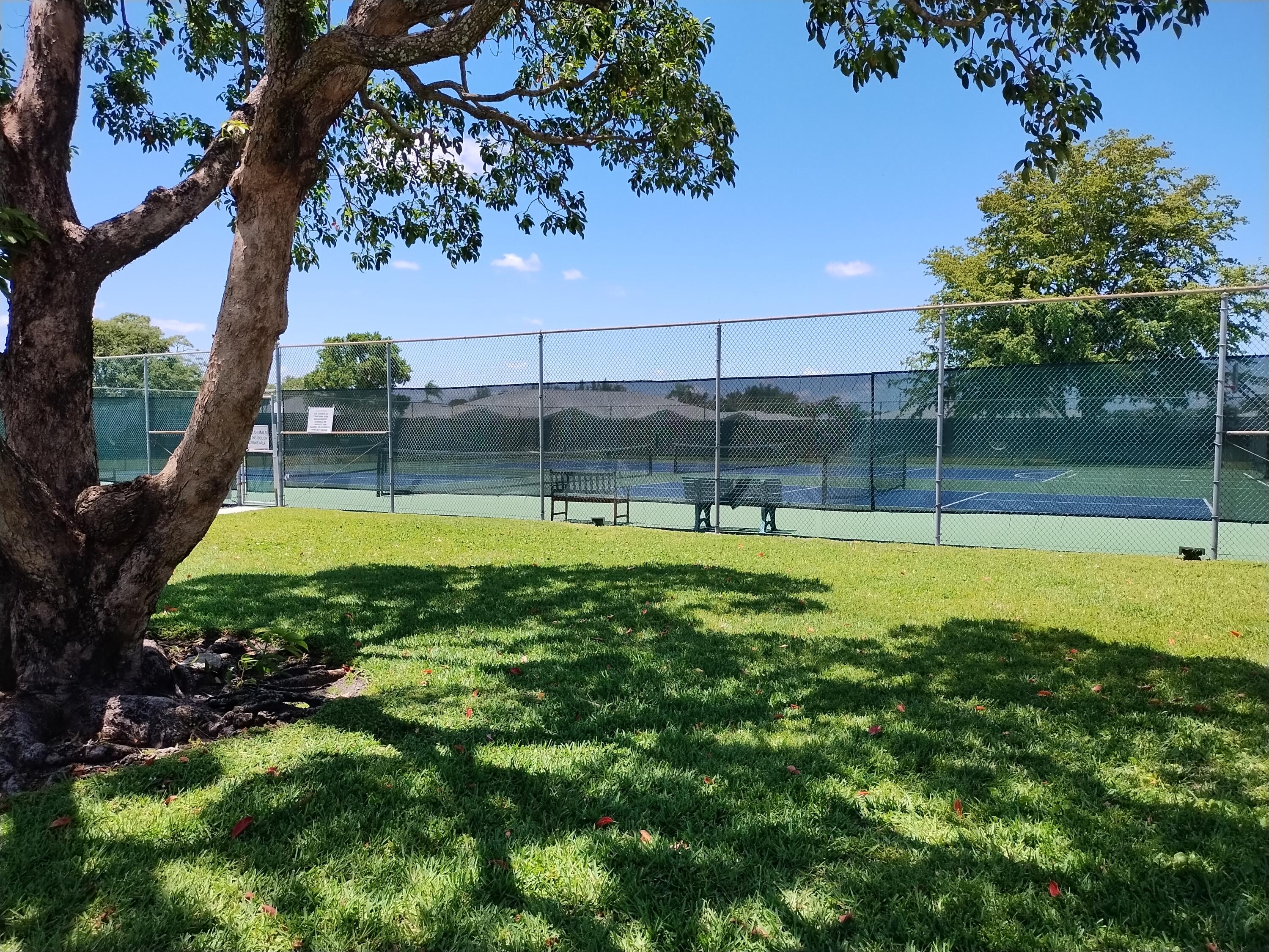 14716 Canalview Drive, Unit D Delray Beach, FL 33484 - Photo 16 of 17 a view of a swimming pool with a yard