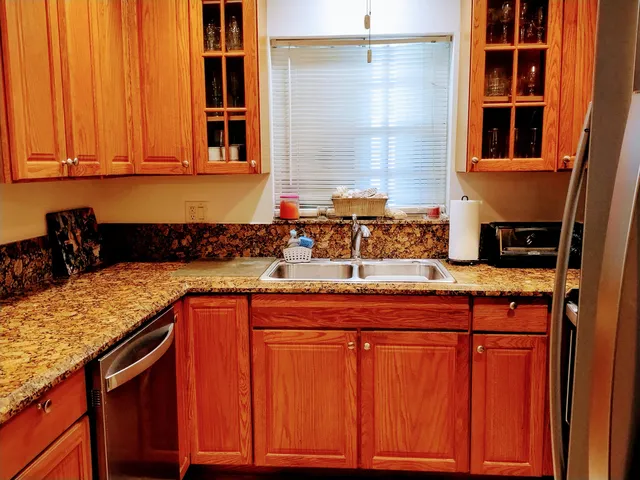 a kitchen with stainless steel appliances granite countertop a sink and cabinets
