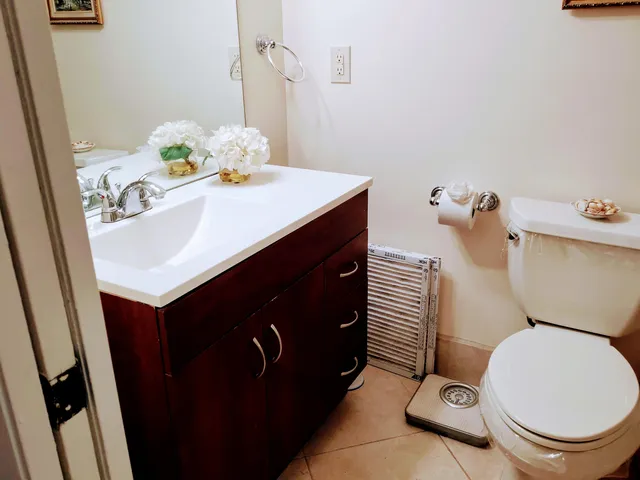 a bathroom with a sink toilet and mirror