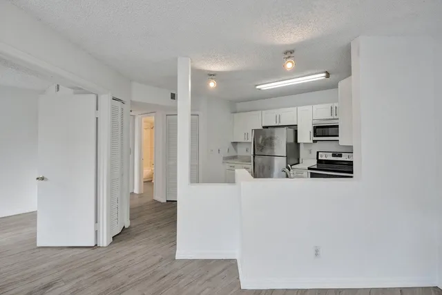 a kitchen with stainless steel appliances refrigerator and cabinets