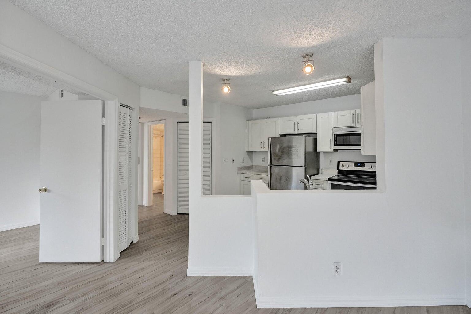 4015 West McNab Road, Unit D204 Pompano Beach, FL 33069 - Photo 11 of 46 a kitchen with stainless steel appliances refrigerator and cabinets