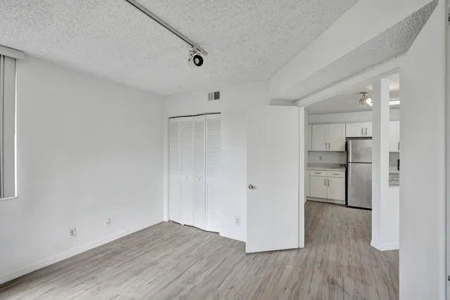 a view of empty room with wooden floor