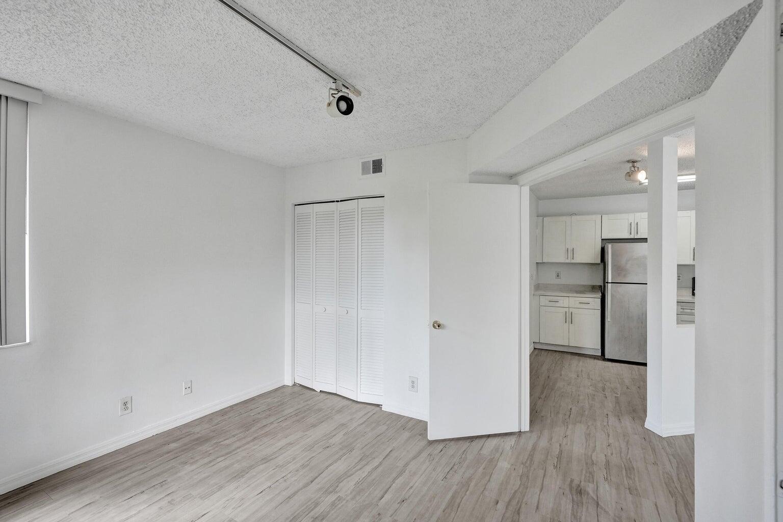 4015 West McNab Road, Unit D204 Pompano Beach, FL 33069 - Photo 18 of 46 a view of empty room with wooden floor