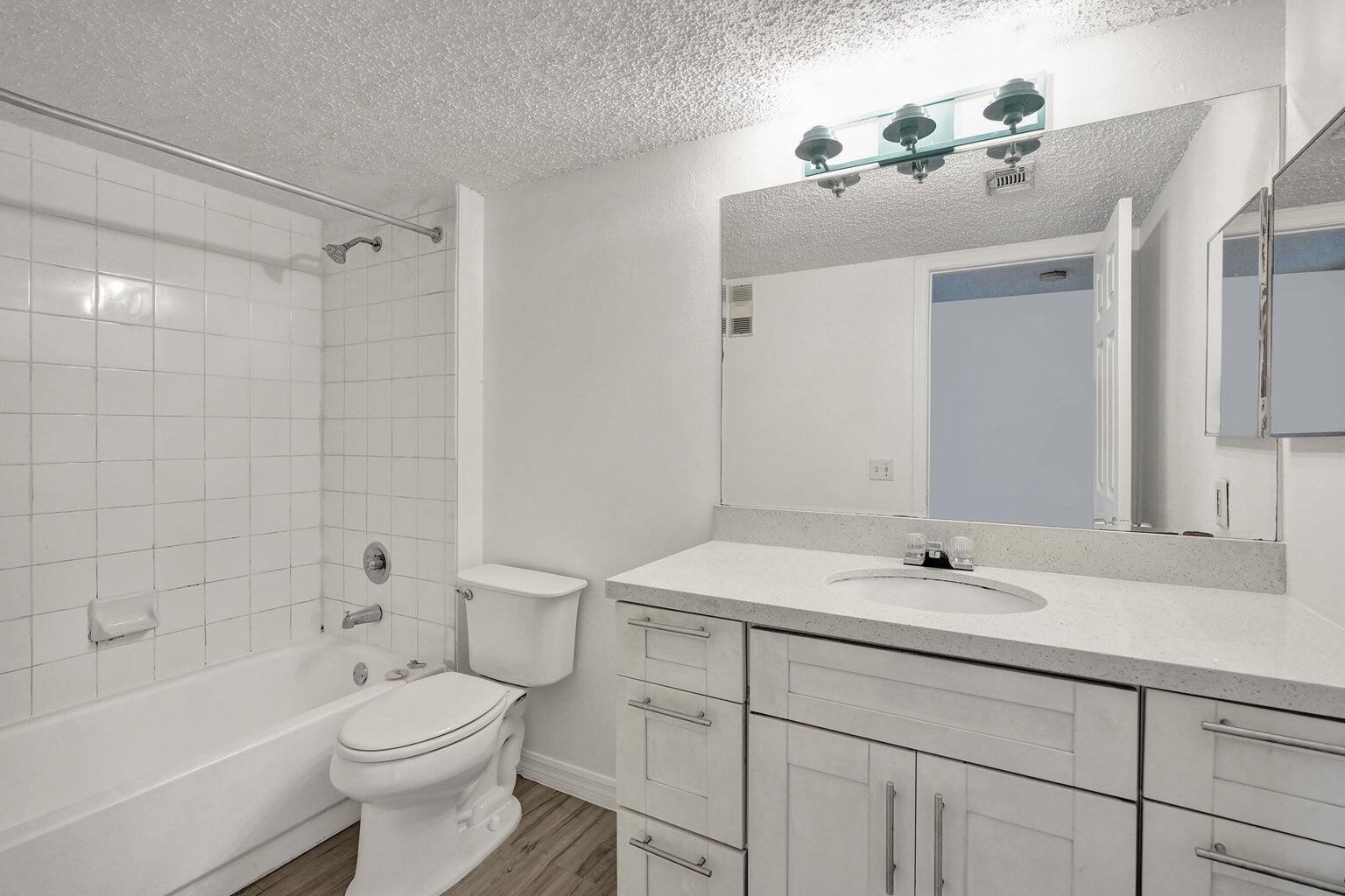 4015 West McNab Road, Unit D204 Pompano Beach, FL 33069 - Photo 23 of 46 a bathroom with a sink a toilet and shower