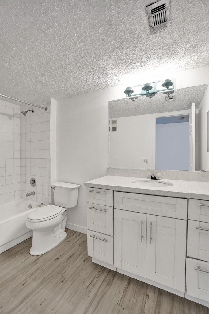 4015 West McNab Road, Unit D204 Pompano Beach, FL 33069 - Photo 24 of 46 a bathroom with a toilet sink and mirror
