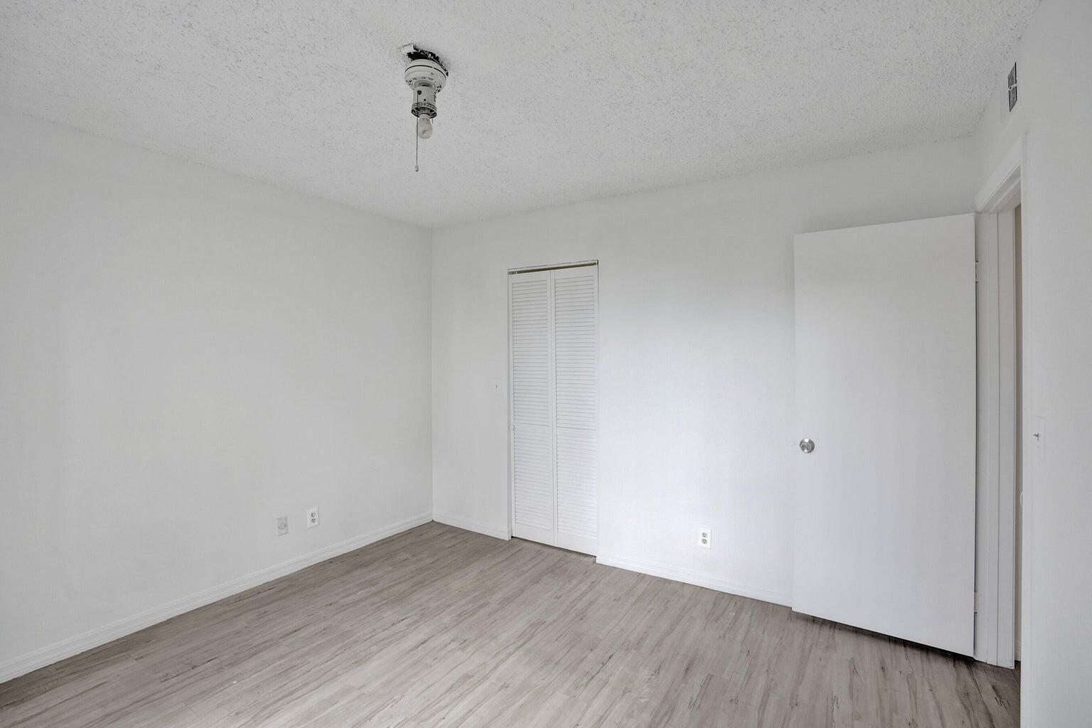 4015 West McNab Road, Unit D204 Pompano Beach, FL 33069 - Photo 27 of 46 a view of an empty room with wooden floor