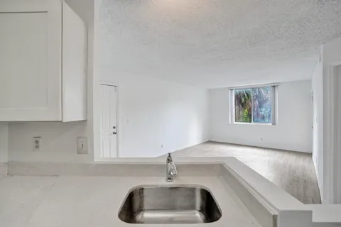 a kitchen with a sink and chandelier