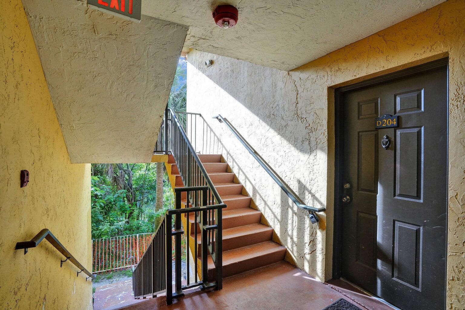 4015 West McNab Road, Unit D204 Pompano Beach, FL 33069 - Photo 4 of 46 a view of staircase with railing and white walls