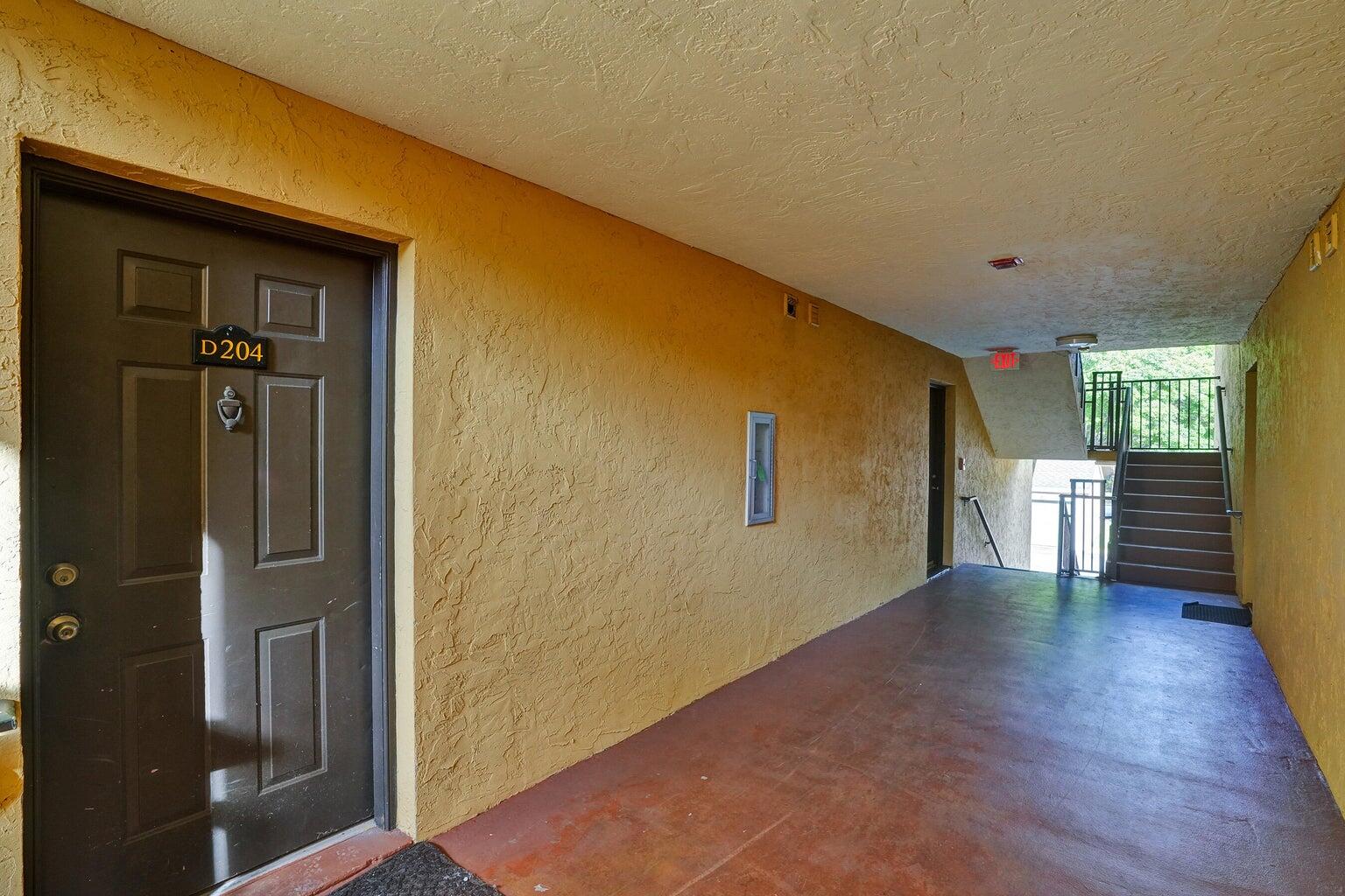 4015 West McNab Road, Unit D204 Pompano Beach, FL 33069 - Photo 5 of 46 a view of a livingroom with wooden floor and a bathroom
