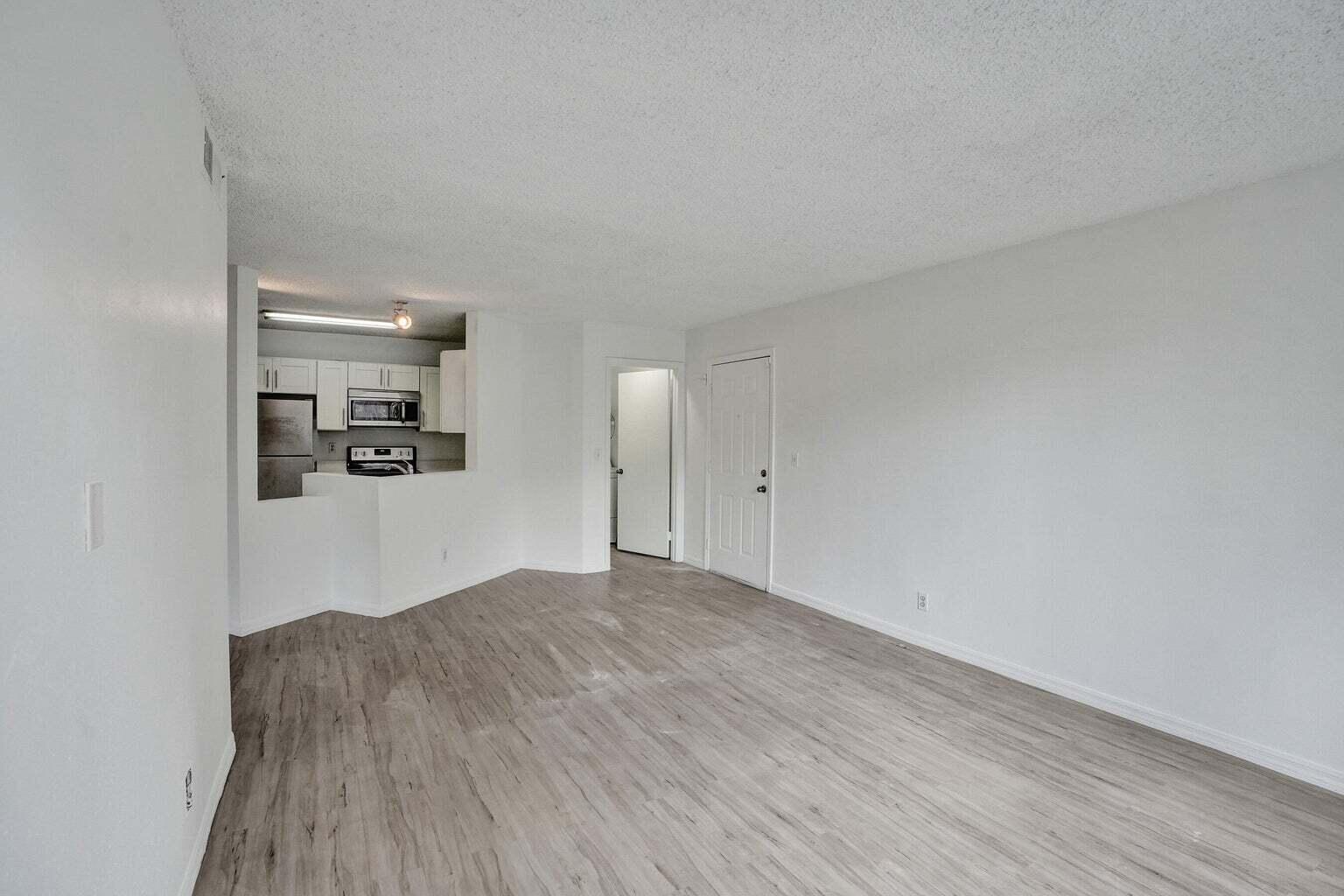 4015 West McNab Road, Unit D204 Pompano Beach, FL 33069 - Photo 8 of 46 a view of empty room with wooden floor