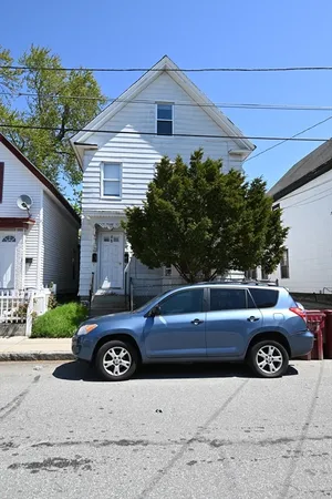 a view of a car parked front of a house