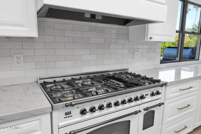 a stove top oven sitting inside of a kitchen
