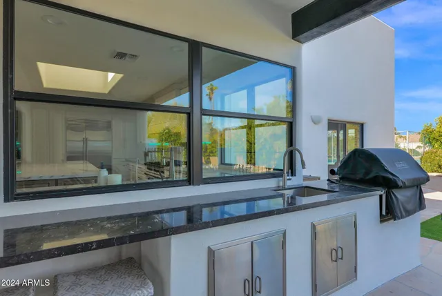a kitchen with a sink and a large window