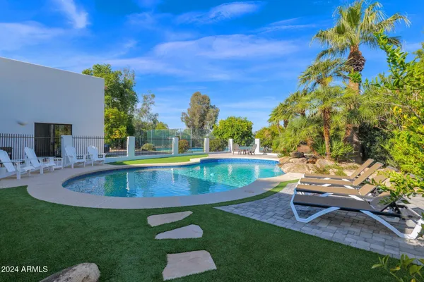 a view of a swimming pool with a yard
