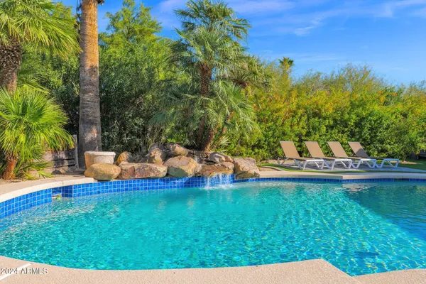 a view of a swimming pool and lounge chair