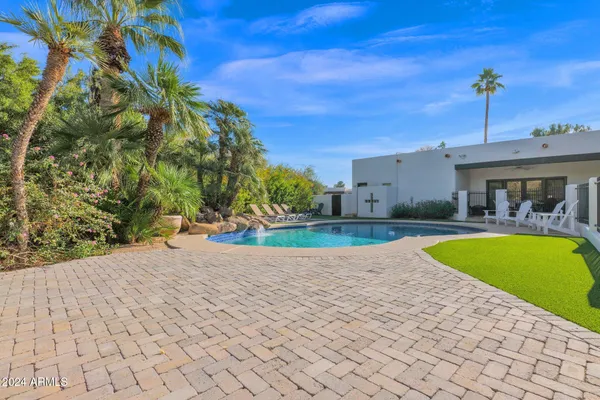 a view of a swimming pool with a patio