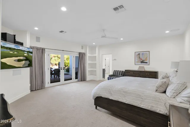 a spacious bedroom with a bed and a walk in closet