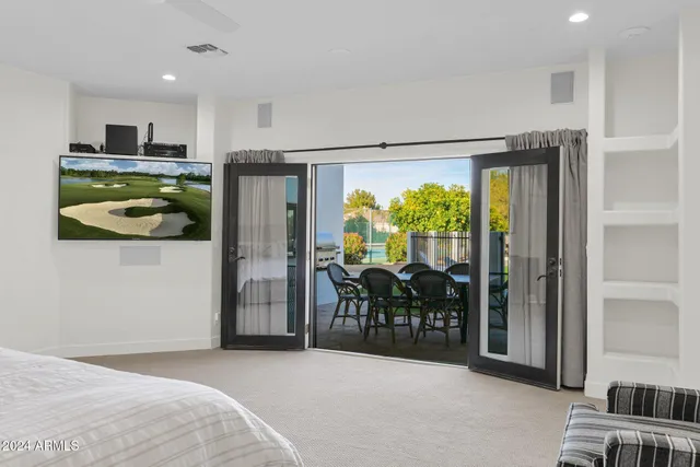 a bedroom with a bed and a view of living room