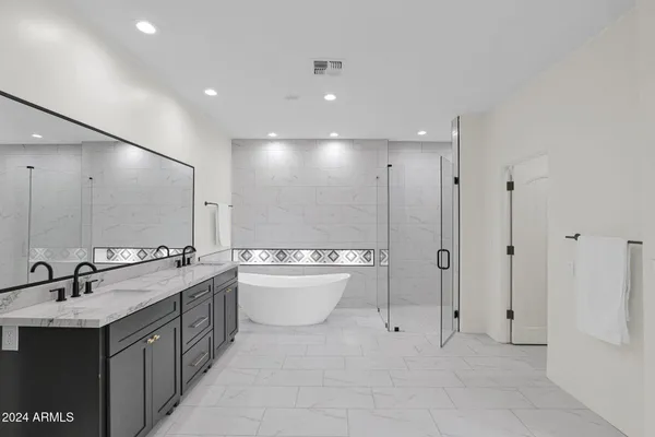 a bathroom with a double vanity sink mirror and toilet