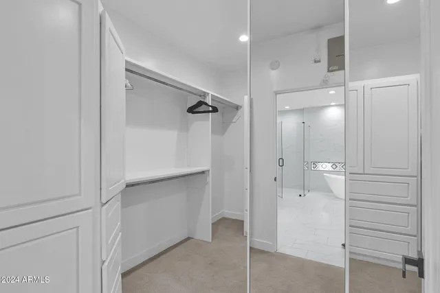 a bathroom with a shower and a glass door