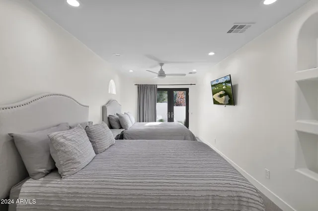 a large bedroom with a bed and a window