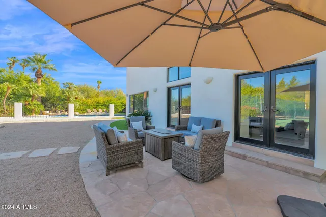 a living room with patio furniture and a potted plants