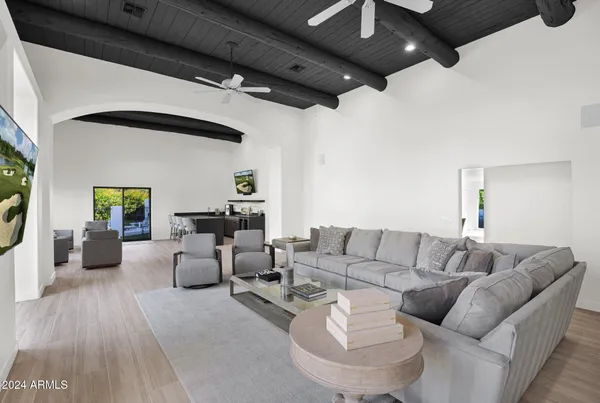 a living room with furniture and a wooden floor