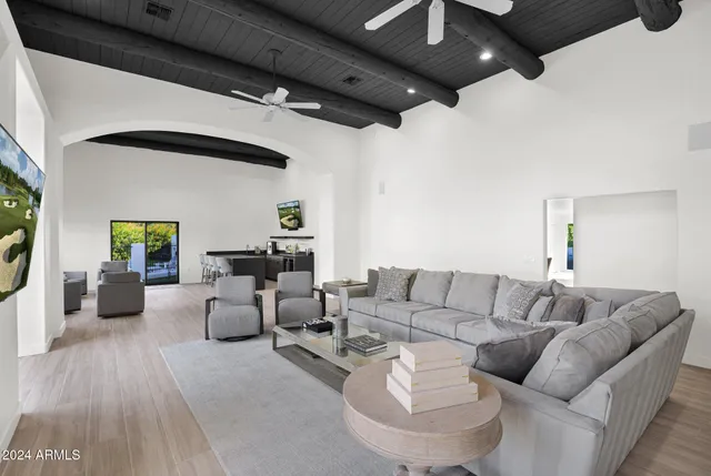 a living room with furniture and a wooden floor
