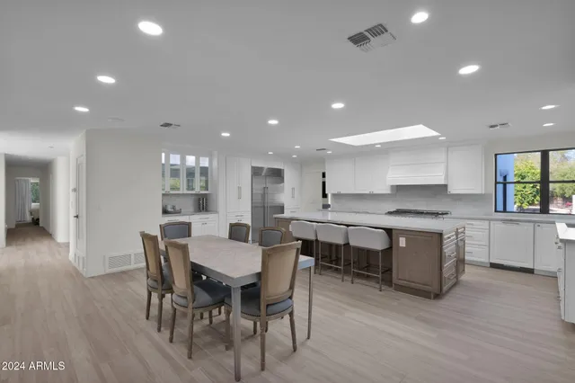 a large kitchen with a table and chairs