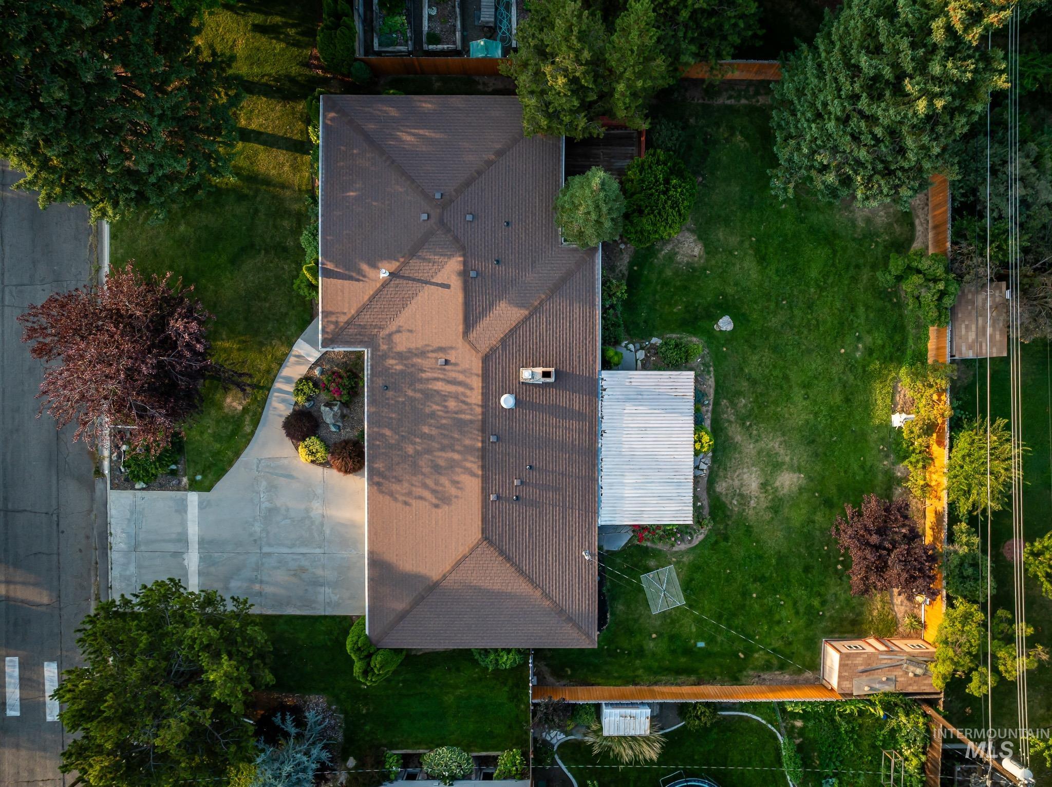 3706 West Clement Road Boise, ID 83704 - Photo 32 of 36 Aerial view of a residential property featuring a spacious backyard with mature landscaping, lush lawn areas, and established trees