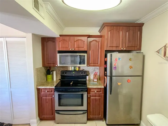 a kitchen with a refrigerator and a stove