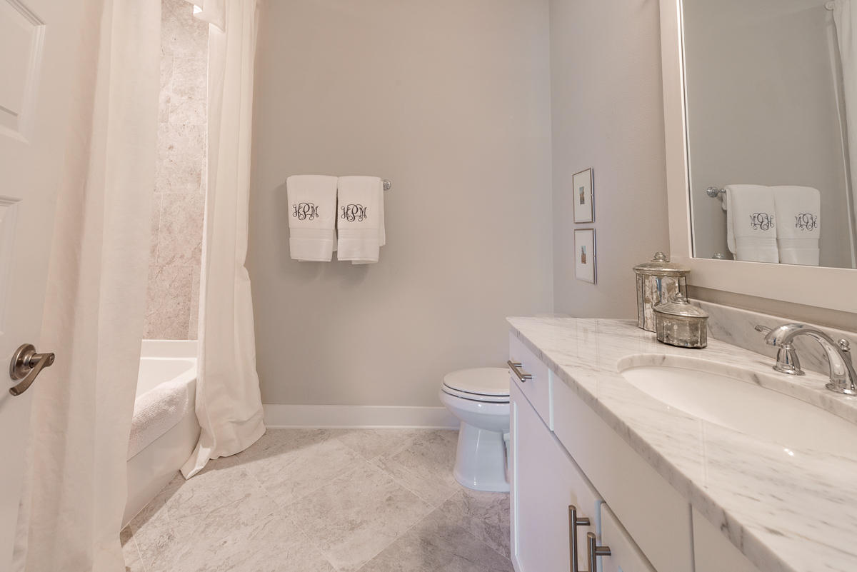 104 Milestone Dr Inlet Beach, Unit A Inlet Beach, FL 32461 - Photo 7 of 10 a bathroom with a granite countertop sink toilet and shower