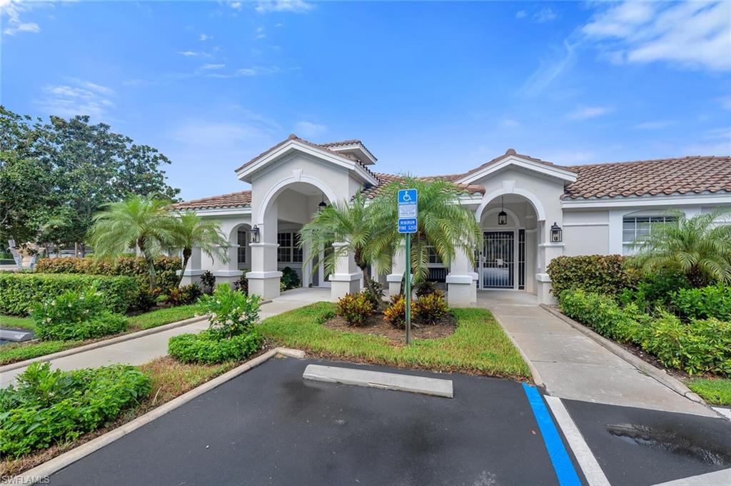 6899 Rain Lily Road, Unit 103 Naples, FL 34109 - Photo 30 of 39 View of building exterior with uncovered parking