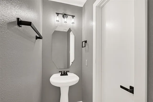 a bathroom with a sink and mirror