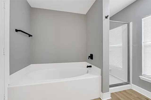 a white bath tub sitting next to a window