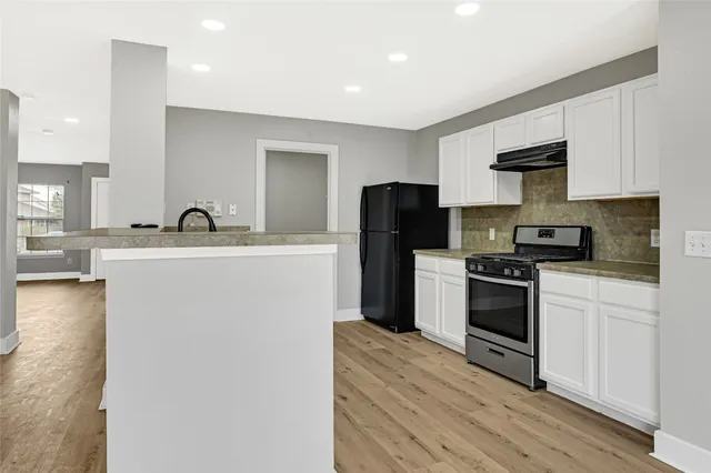 a kitchen with stainless steel appliances a refrigerator stove and sink