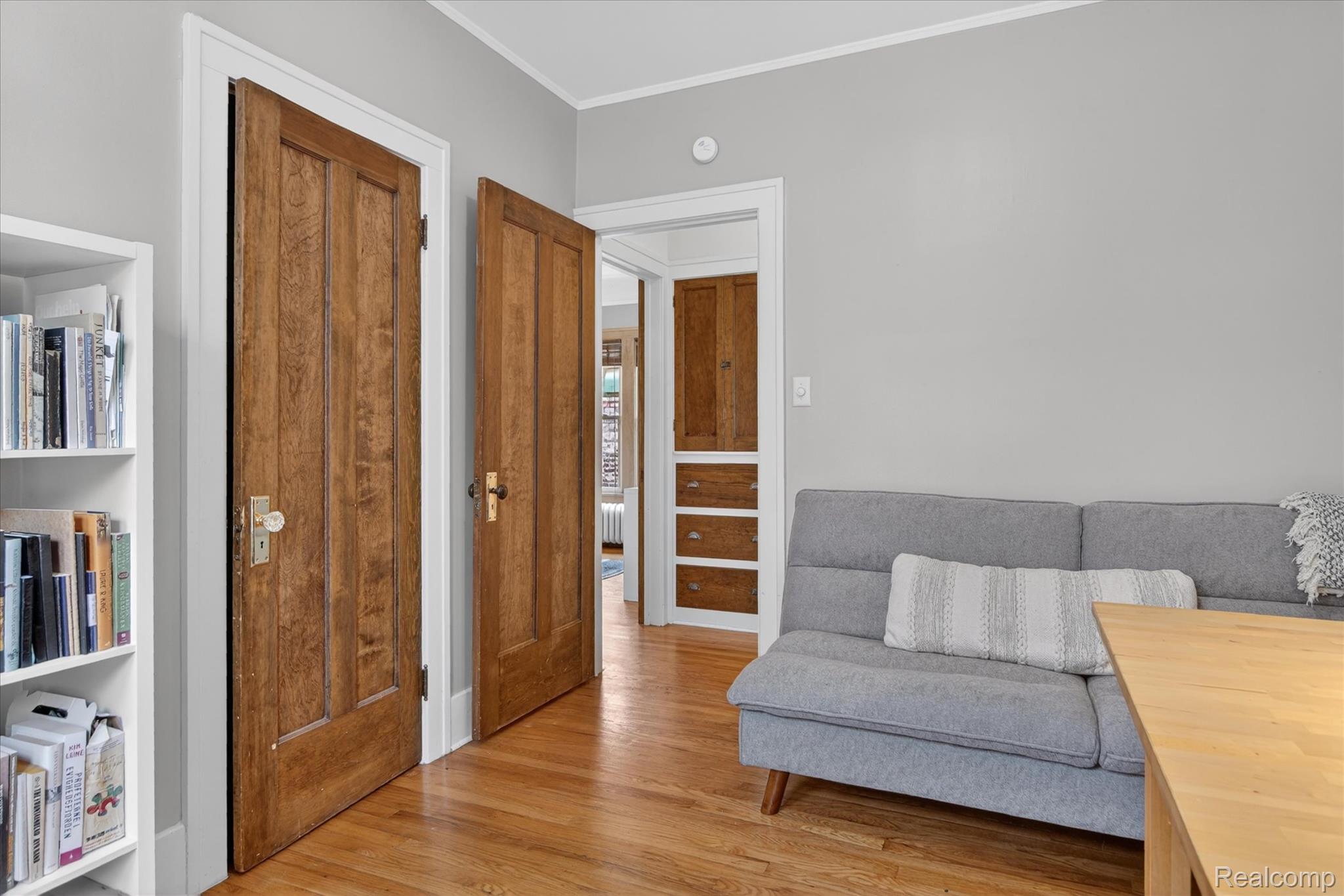 925 Nottingham Road Grosse Pointe, MI 48230 - Photo 25 of 46 Living area featuring crown molding and light wood finished floors
