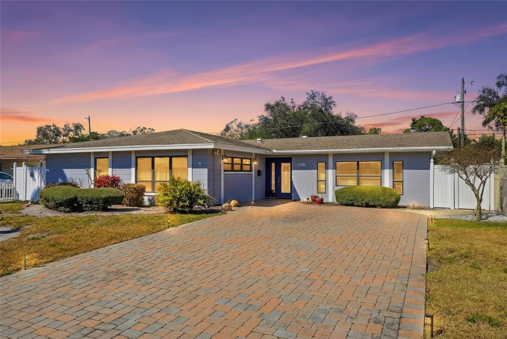 a front view of a house with yard and green space